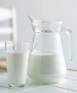Pitcher and Glass of Milk --- Image by © Bloomimage/Corbis