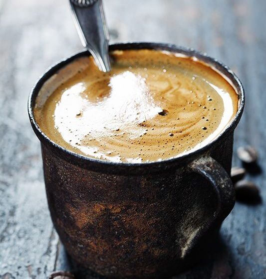 Old coffee cup on dark rustic  background